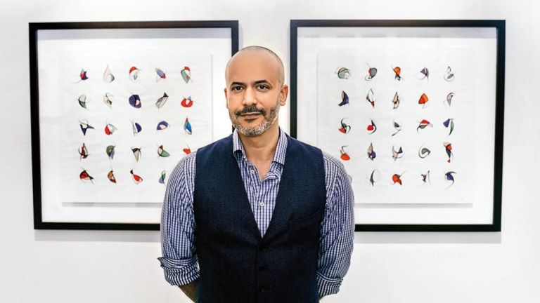 Majid Alyousef, a contemporary calligraphy artist, creating an abstract artwork that blends traditional Arabic script with modern artistic elements.