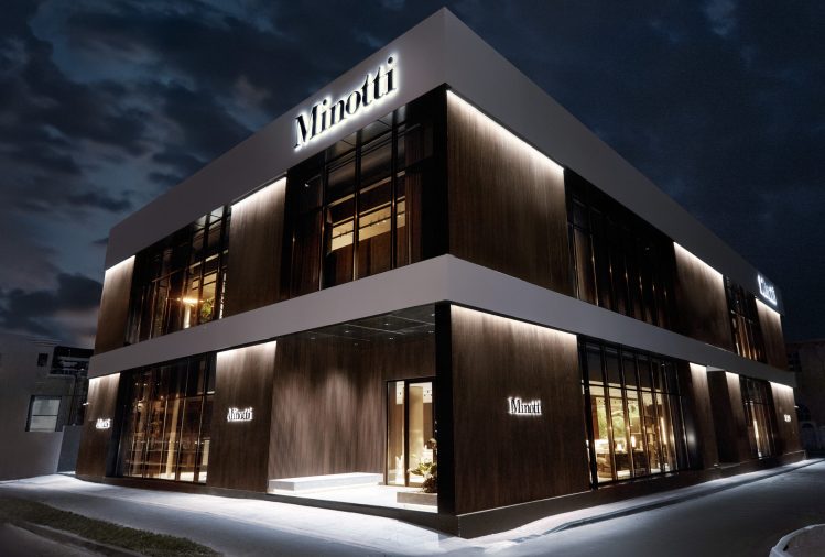 Exterior view of Minotti Dubai flagship store, showcasing a modern architectural facade with a large portal entrance.