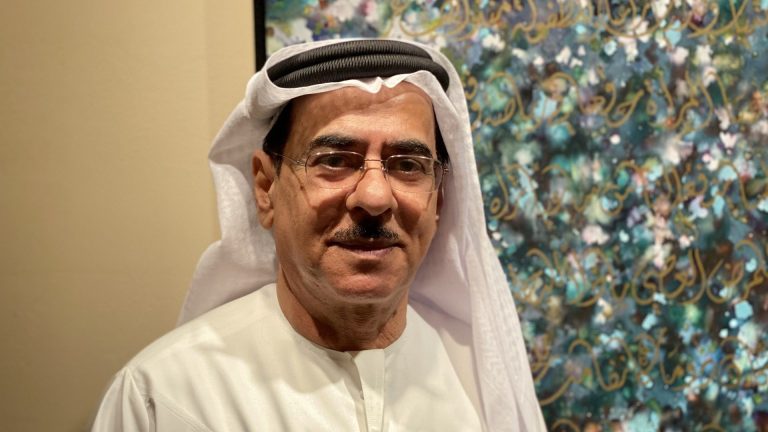 Mohammed Mandi creating intricate Arabic calligraphy with traditional tools.