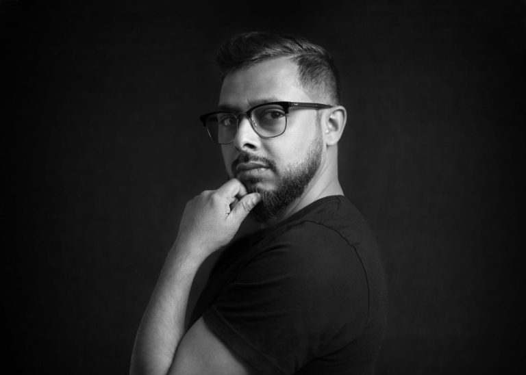 Ruh Al-Alam creating an artwork that blends traditional Arabic calligraphy with modern design elements, showcasing his unique artistic style.