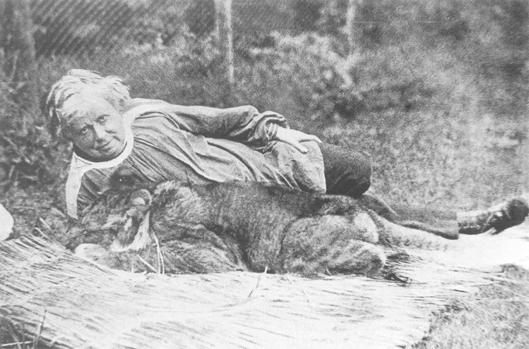 A grainy black-and-white photo of an old white lady snuggling a small ioness.