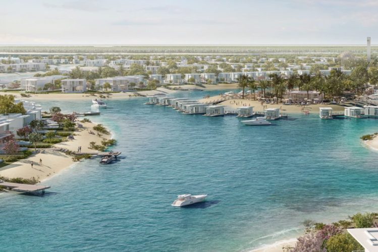 An aerial view of Ramhan Island in Abu Dhabi, showing the turquoise blue waters and lush greenery of the island, with the city skyline in the distance