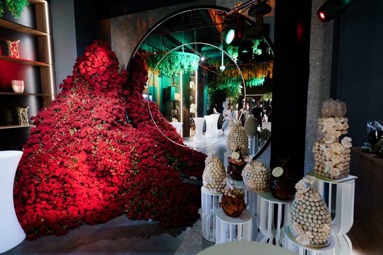 A beautifully crafted floral centerpiece with cascading roses and greenery, perfect for weddings, corporate events, and luxury home decor in Dubai.
