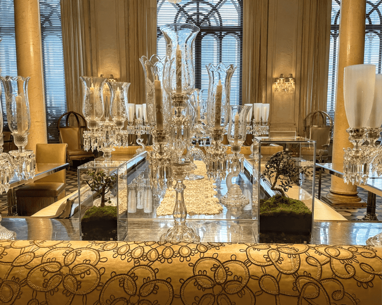 Self-sustaining plantarium by ARBOLIVIDA, encased in crystal glass, featuring exotic plants and gold-infused substrate, displayed in a luxury interior setting.